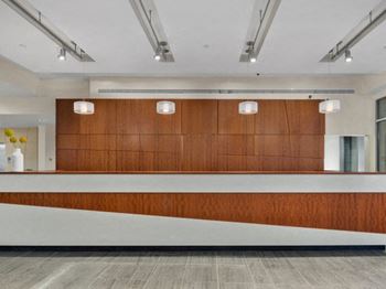 a large reception desk with a wooden wall behind it